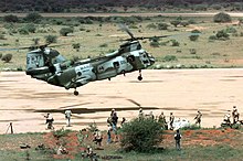 US forces deploying to Baledogle on 13 December 1992 Long shot, right side view, of a A United States Marine helicopter, CH-46 Sea Knight, hovering a few feet off the dirt runway at the Baledogle Landing Zone, Somalia. In the foregrou - DPLA - 75d34ae4140f94e17d92a0c387ddedad.jpeg