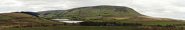 A panoramic image of Pendle Hill in 2012 showing the northeast slopes, known as the Big End, overlooking Black Moss Reservoirs on the edge of Barley-w