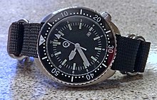 Technical ceramic used as a durable top material on a diving watch bezel insert Qimei watch on Zulu strap.jpg
