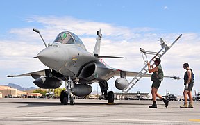 French air force ground crewmen provide a boarding ladder for a Rafale fighter aircrew upon upon their arrival at Nellis Air Force Base for the Red Flag 08-4 exercise