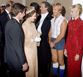 Queen Elizabeth II and Prince Philip meeting Roger Woodward, Paul Hogan, and Olivia Newton-John at a Sydney concert in 1980. Royal Charity Concert 1980 (cropped).jpg