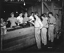 SC 190521 - Movie star Ray Milland moves through the chow line in the mess hall of the 8th Special Service Co. on Espiritu Santo, as the company cooks get a helping hand from... (49639432762).jpg