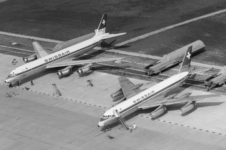A DC-8 (left, engine cowlings open) and a competing Convair CV-990 (right, with distinctive anti-shock bodies) Swissair Douglas DC-8 and Convair CV-990 at Zurich from above.tif