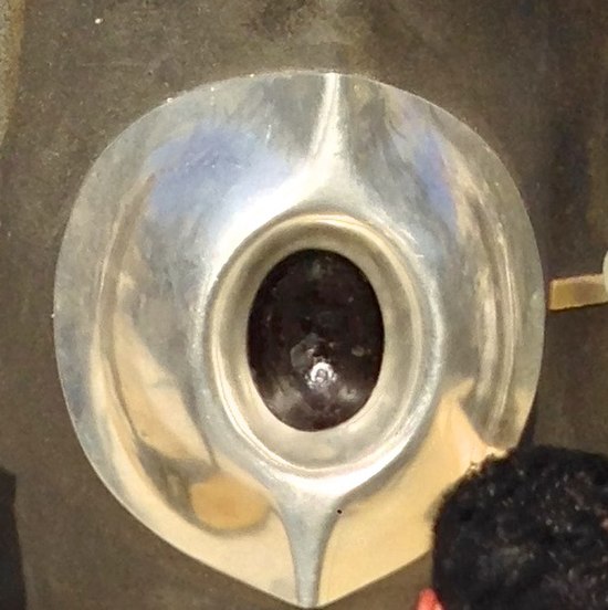 The Black Stone is seen through a portal in the Kaaba