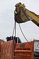 Trench safety - lifting a properly rigged trench box (9247877887).jpg