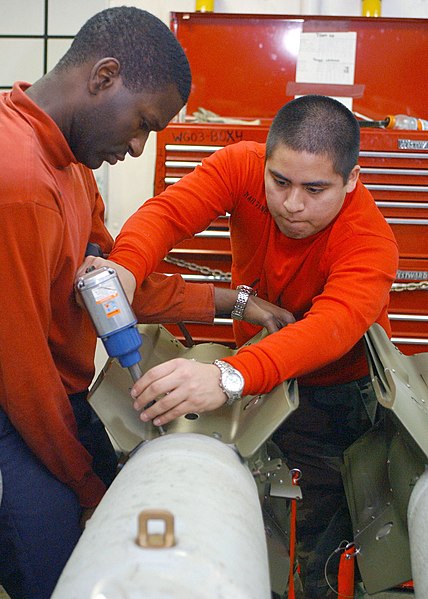 File:US Navy 030327-N-1328C-505 Airman Recruit Jose Martinez (right) assembles a bomb aboard USS Theodore Roosevelt (CVN 71).jpg