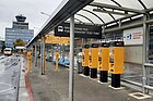 Čeština: Automaty na prodej jízdenek na městskou hromadnou dopravu před Terminálem 1 na Letišti Václava Havla v Praze English: Václav Havel Airport Prague, Terminal 1, ticket vending machines for public transport.