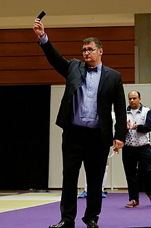 A referee in fencing issues a black card to a fencer, excluding the fencer from the remainder of the competition Venezuela v Korea Challenge RFF team t120624.jpg