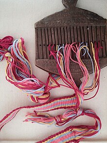 A rigid heddle on a backstrap inkle loom, unspanned. WARP-FACED TAPE ON A RIGID HEDDLE.jpg