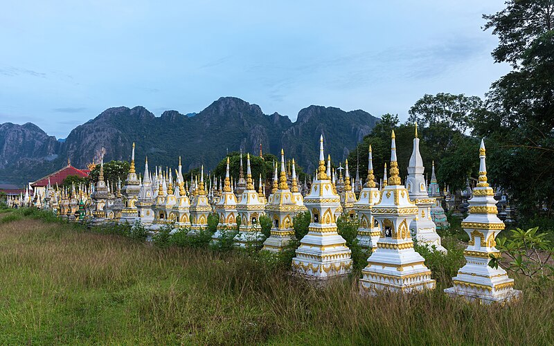 File:White and golden graves in a Buddhist cemetery at sunrise in Vang Vieng, Laos.jpg