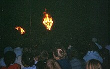 Campers hearing the challenge under the flaming triangle at a closing campfire. Ymca wanakita campfire.jpg