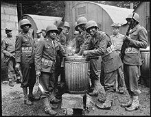 African American soldiers in Northern Ireland in 1942. "Negro soldiers draw rations at the camp cook house at their station in Northern Ireland. Detachments of Negro troops we - NARA - 535544.jpg