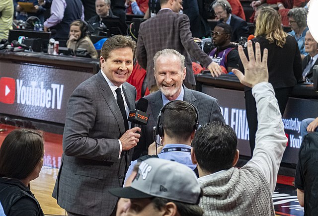 Toronto Raptors commentary team members Matt Devlin and Jack Armstrong in the Scotiabank Arena during Game 2; note the advertisement of YouTube TV (de