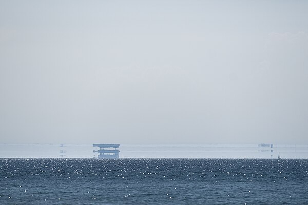 A Fata Morgana seen over the Baltic Sea, 2016. The mirage consists of multiple upright and inverted images over the original object.