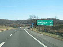 A mileage sign, as well as reassurance markers and mile post in the background, on the I-70 in Pennsylvania 70 PA mileage.JPG