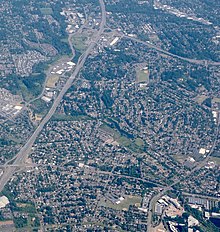 Aerial view, from the west, with Marlene Village in the lower half of the frame and the Sunset Highway at left Aerial of Cedar Hills and Marlene Village from west (2018).jpg