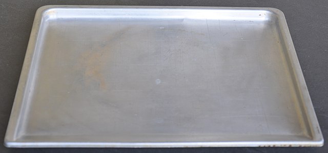Simple tray with rim. This shape is called a jelly roll pan because the sponge cake for a jelly roll can be baked in it.