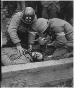 American soldier lies dead in gutter of Schevenhutte, Germany, after being hit by flak from German guns. Medics had... - NARA - 531505.tif