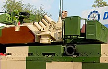 One of the four all-bearing laser warning receivers combined with IR jammer (top) and 360 degree independently rotating grenade launcher (bottom). Both are part of the ALWCS, and operate autonomously