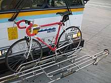 Bike rack on a Highway 17 Express bus, holding a bike in one of three slots. Bikerack for three bicycles on Highway 17 Express Bus.jpg