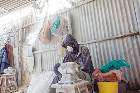 Dennis Ojala is softening and cutting bones into different shapes and sizes, This process produces a lot of white dust which is harmful to the lungs.