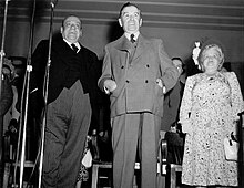 Public reconciliation of Camillien Houde (left) and Maurice Duplessis (centre) during a political assembly at Montreal's Saint-Jacques market in July 1948. Houde had previously come to good terms with Duplessis in 1944, when the long-time mayor of Montreal was arrested for resisting conscription. Camillien Houde et Maurice Duplessis 1948.jpg