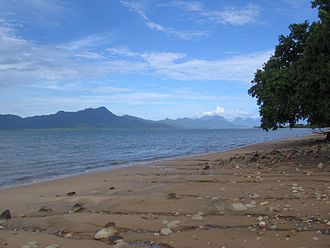 Oyster Point, protruding into the Hinchinbrook channel (right), viewed from Cardwell. The mountains on the left are Hinchinbrook Island. Cardwell.jpg