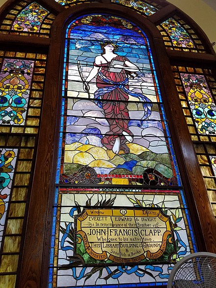 Clapp Memorial Library south window, depicting literature as a figure in thought and repose. This window is dedicated to the memory of John Francis Clapp and is thought to have been fabricated by H.E. Hartwell, a New York decorator and designer. Clapp Memorial Library south window.jpg