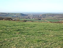 Corfe Castle sitting in its gap in the Purbeck Hills in Dorset