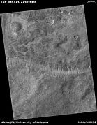 Wide view of a surface with lines of pits, as seen by HiRISE under HiWish program.