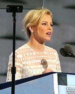 Hunger Games actress Elizabeth Banks hosted the second night when she mocked Donald Trump's entrance the previous week. She received negative reviews from conservative media outlets. Brian May of the band Queen commended her for the gag. Elizabeth Banks DNC July 2016 (cropped2).jpg