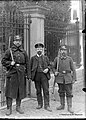 Un fonctionnaire et deux soldats allemands posent sous l'objectif de Léon Peret, à côté du portail de l'immeuble Bourguignon, à Marche-en-Famenne.