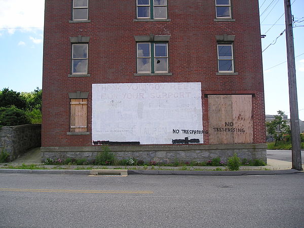 The same house, June 10, 2007. The "thank you" is still visible, but some windows are broken, and others are boarded up, and "No Trespassing" has been