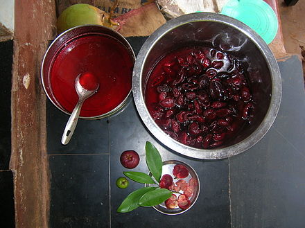 The vessel on the left contains syrup which is obtained from the vessel containing kokum rinds, on the right. The syrup is used to make kokum sherbet.
