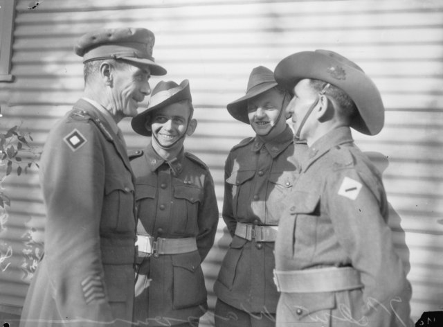 Vasey chats with three of his men. Vasey's concern for and rapport with his men was a key factor in his success as a general.