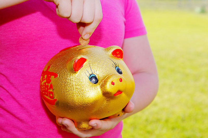 File:Girl Purring Money Into Piggy Bank.jpg