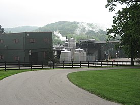 A color photograph of a building, a distillery