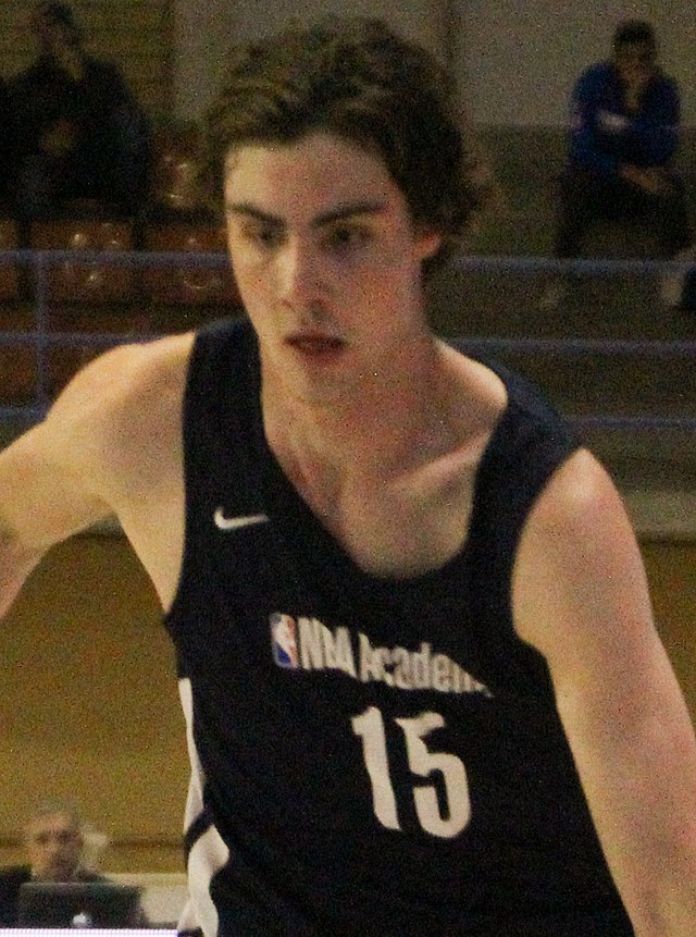 Picture of a man wearing a basketball jersey.