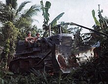 B Company, 65th Engineer Battalion clear vegetation from around the town of Phu Hoa Dong with a D-7 bulldozer, 26 January Jungle clearing, Operation Cedar Falls, 26 January 1967.jpg