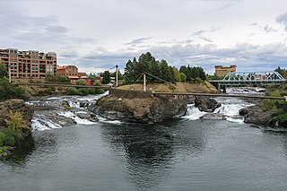 Spokane is a city in and the county seat of Spokane County, Washington, United States. It is in eastern Washington along the Spokane River adjacent to the Selkirk Mountains and west of the Rocky Mountain foothills, 92 miles (148 km) south of the Canada–U.S. border, 18 miles (30 km) west of the Washington–Idaho border, and 279 miles (449 km) east of Seattle along Interstate 90.