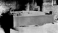 Michelson and Morley's interferometric setup, mounted on a stone slab that floats in an annular trough of mercury Michelson morley experiment 1887.jpg