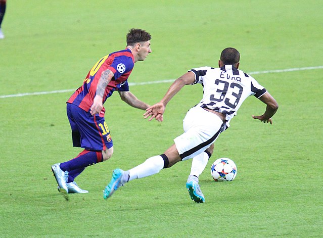 Messi challenging Patrice Evra in the Champions League Final