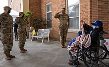 Members of the New York Army National Guard visit a nursing home resident in December 2020 New York National Guard nursing home.jpg