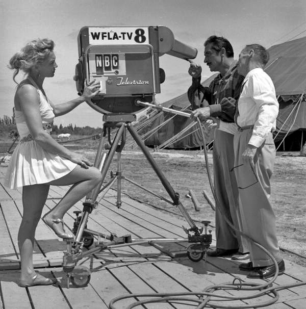 Circus performers looking at the new Kaleidoscope camera used by WFLA-TV to film a documentary about the Cristiani family.