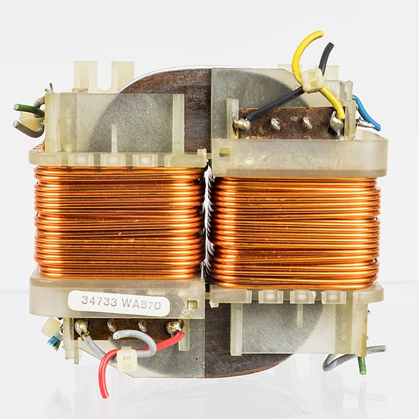 An O-core transformer consisting of two coils of copper wire wrapped around a magnetic core