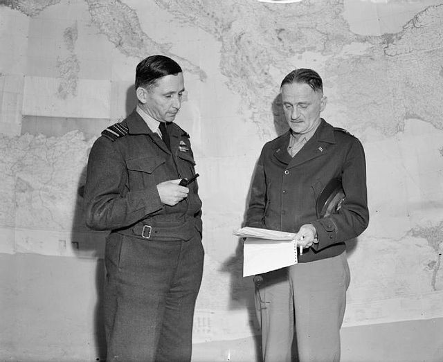 Air Chief Marshal Sir Arthur Tedder, Commander-in-Chief, Mediterranean Air Command (left), in conference with Major General Carl Spaatz, Commander of 