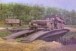 Polish SKOT S-260 Inż towing a trailer crossing a tank launched bridge