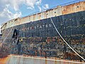 The rusting ship's name and bow.