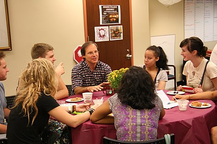 Students and professor in conversation during orientation at Shimer College.