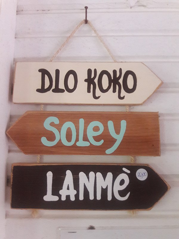 Sign in Martinican Creole: Dlo Koko ("coconut water", from French de l'eau de coco) Soley ("Sun", from soleil) Lanmè ("the sea", from la mer)